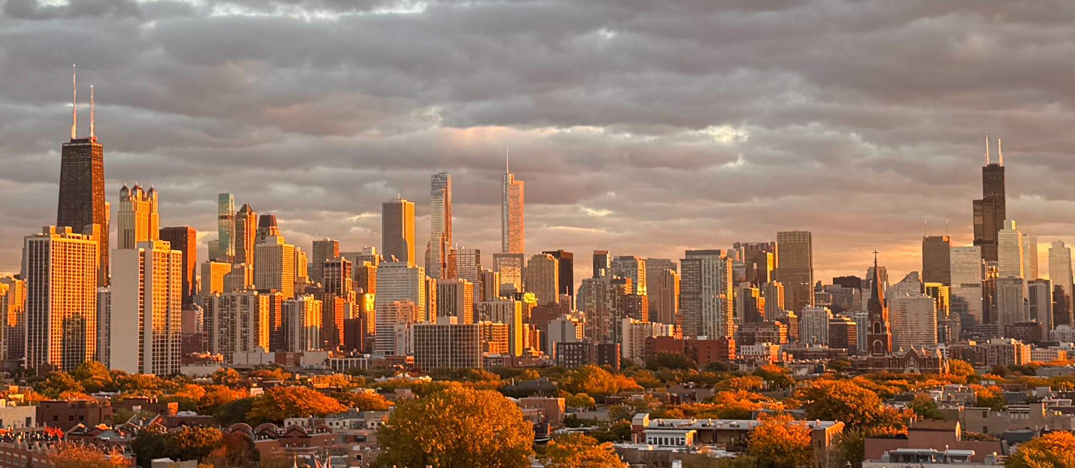 Chicago skyline at sunset beneath dramatic clouds